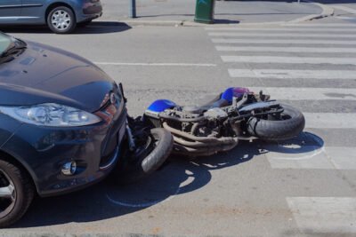 Motorcycle under car bender after accident