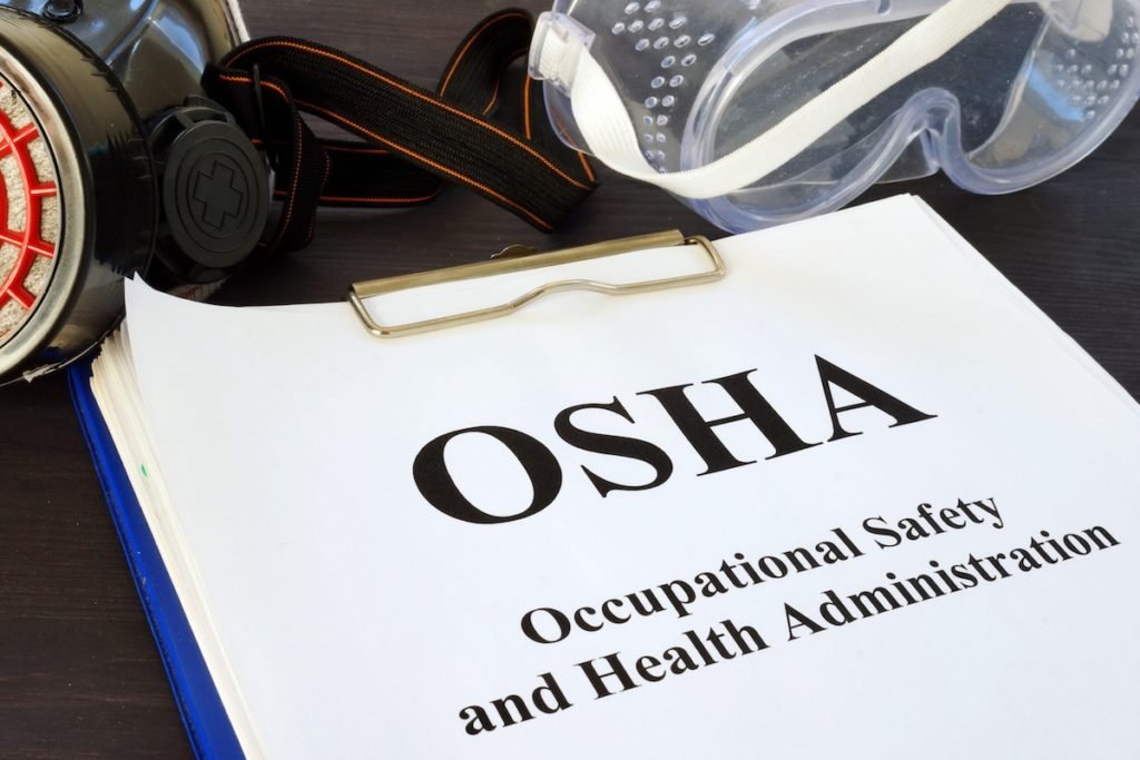 Pile of documents with Occupational Safety and Health Administration OSHA.