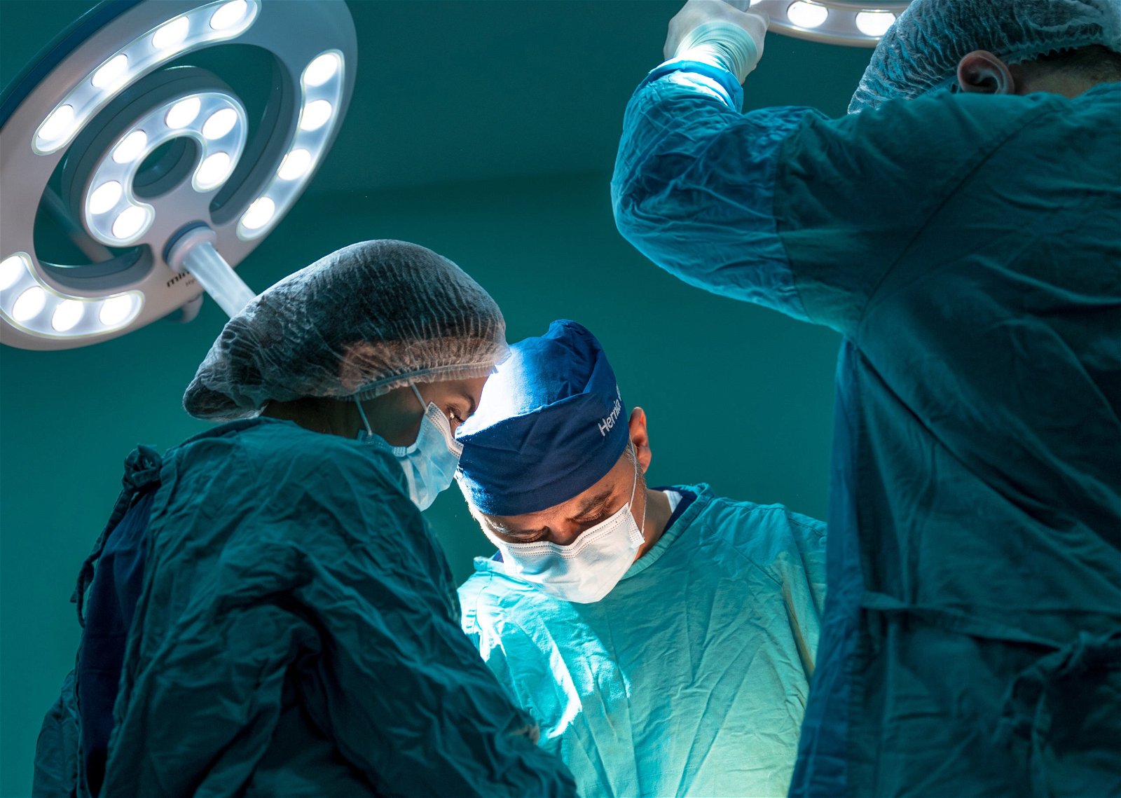 Three doctors during surgery