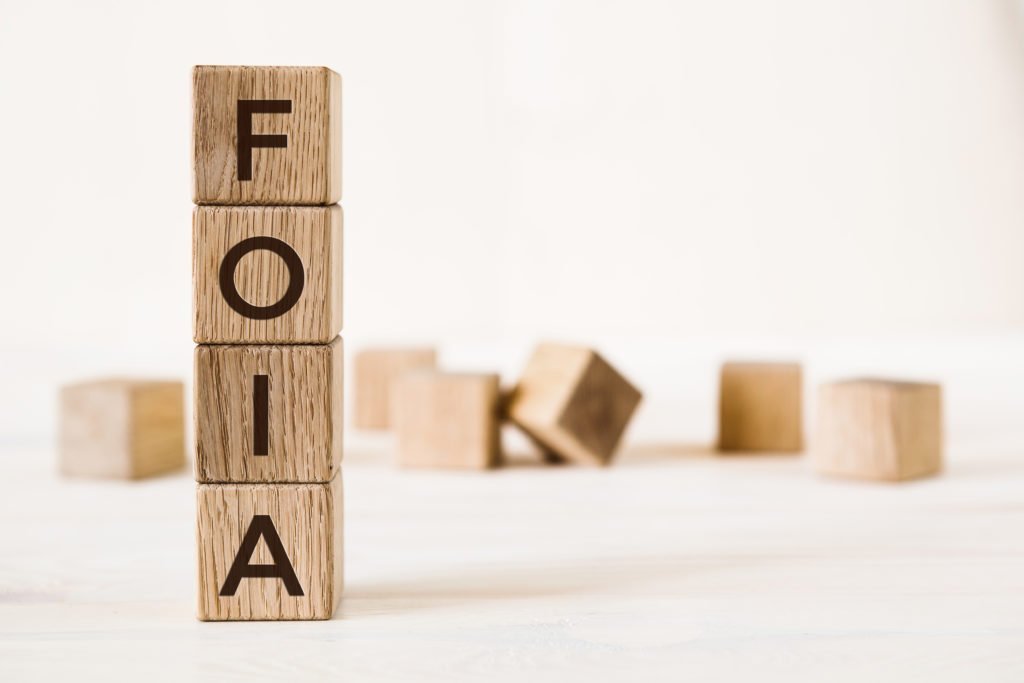 Word foia. Wooden small cubes with letters on white background with copy space available. Business Concept image.