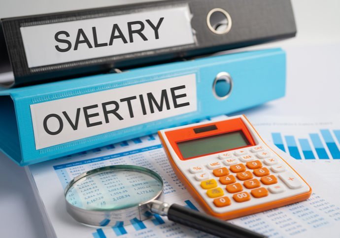 Salary, Overtime. Binder data finance report business with graph analysis in office.