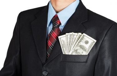 Dollars in businessman suit pocket