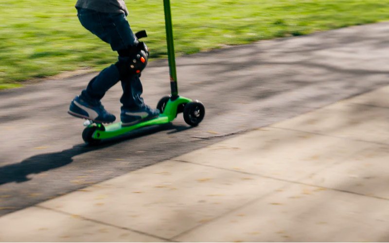 Young Boy Riding a Scooter