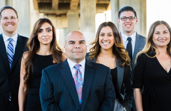 Gastelum Law Team smiling at the camera.