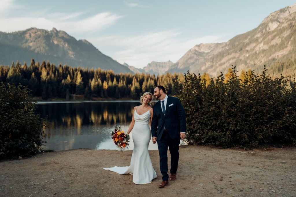 A couples together towards the camera on their wedding day in the mountains.