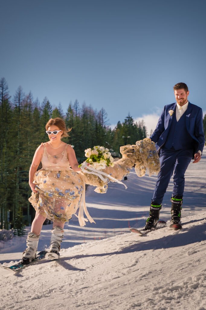 A couple of skis on a sunny day in their wedding attire.