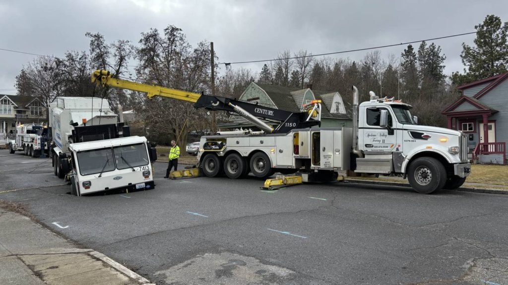 Garbage truck falls into sinkhole in Spokane - KIRO Seattle