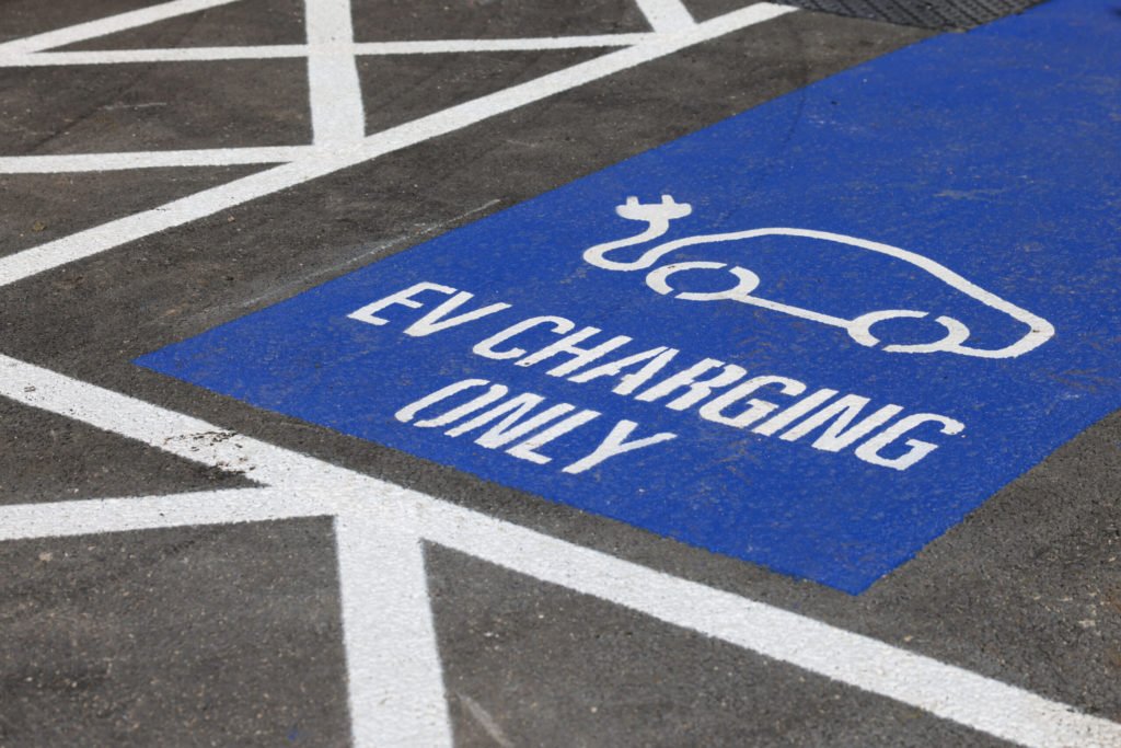 An EV charging bay sign at the NEC Group Gigahub public electric vehicle charging hub in Birmingham, UK, on Thursday, Sept. 7, 2023. The UK is seeking to install at least 300,000 public EV chargers by the end of the decade, as part of its plan for net zero greenhouse gas emissions by mid-century. Photographer: Hollie Adams/Bloomberg via Getty Images