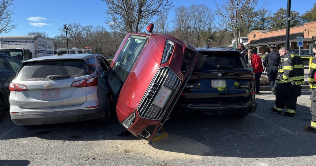 Car ends up sandwiched between SUVs in Wellesley shopping plaza crash - CBS Boston