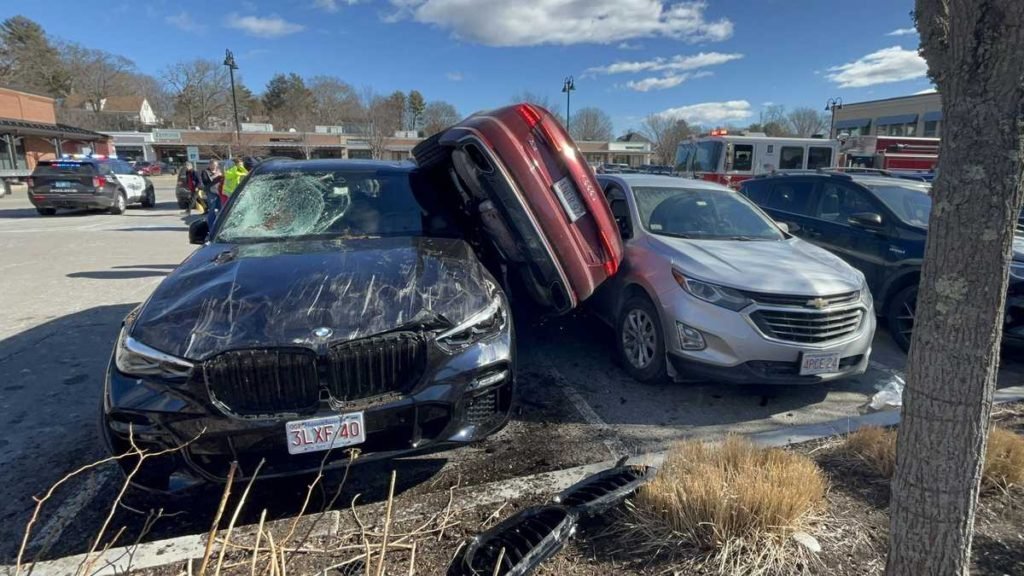 Car wedged between vehicles after Wellesley parking lot crash - WCVB Boston