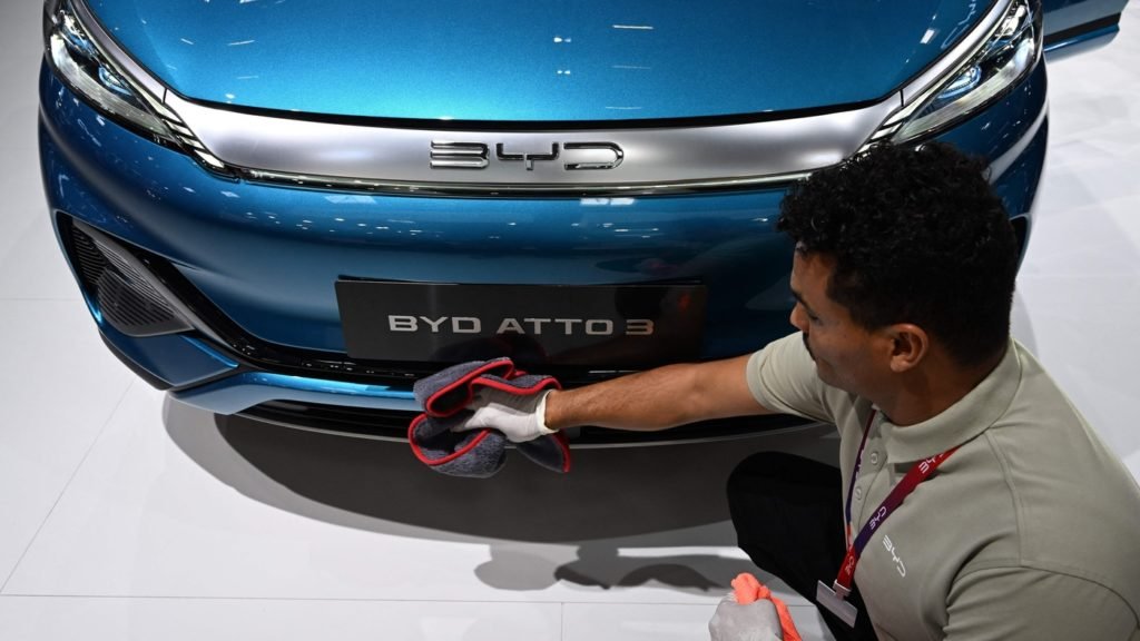 A man polishes an Atto 3 car of Chinese car maker BYD at the International Motor Show (IAA) in Munich, southern Germany, on September 4, 2023. Germany's IAA MOBILITY auto show, one of the world's largest, will be open for the public from September 5 to 10, 2023 and showcase all car-related topics. (Photo by CHRISTOF STACHE / AFP) (Photo by CHRISTOF STACHE/AFP via Getty Images)