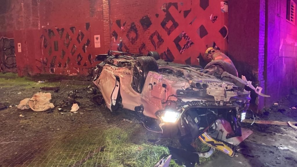 Car launches off Interstate 5, hits light pole and catches fire - KGW.com