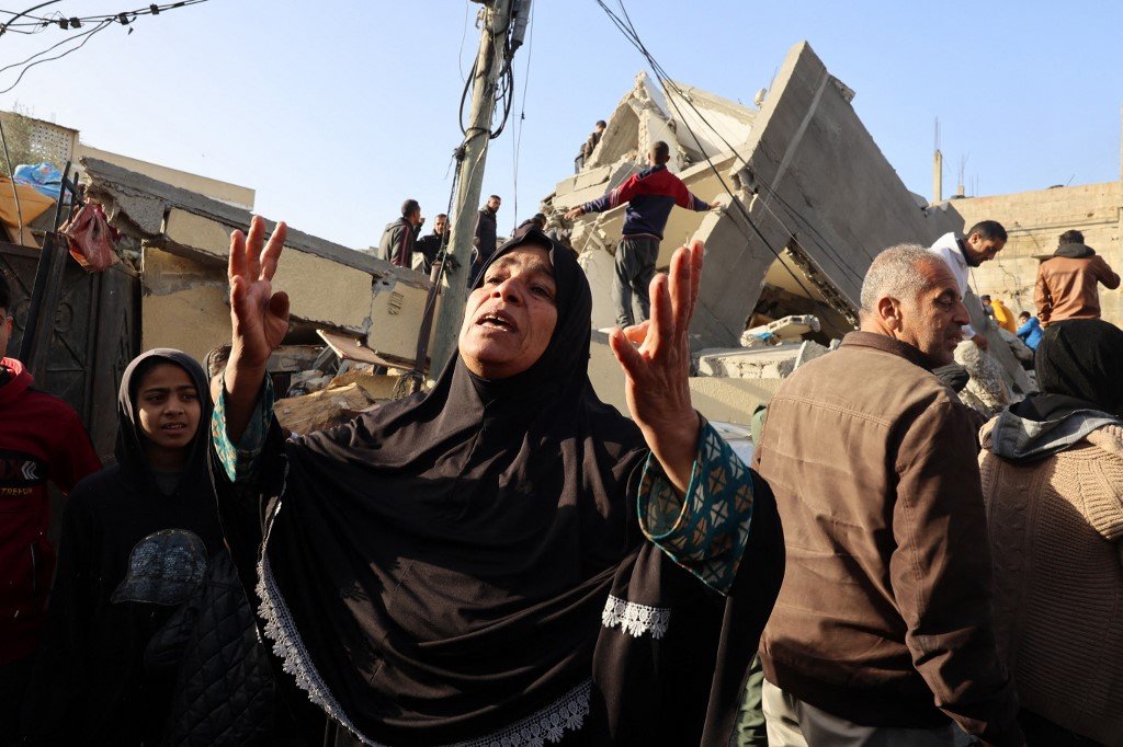 A Palestinian woman reacts in front of the Abu Anza family home destroyed in an overnight Israeli air strike in Rafah in the southern Gaza Strip on March 3, 2024, as  the conflict between Israel and the Palestinian militant group Hamas continues. (Photo by SAID KHATIB / AFP)