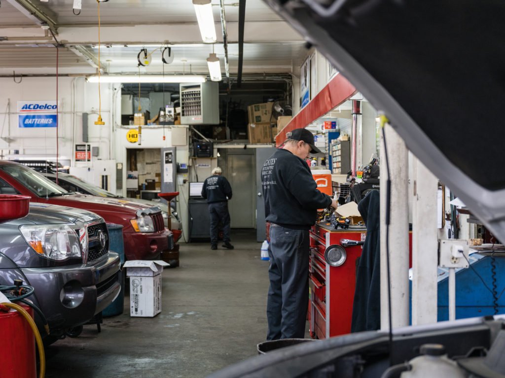LOUISVILLE, KY - JANUARY 13: An auto mechanic stands at a workbench at Gates Automotive Service on January 13, 2022 in Louisville, Kentucky. Due to the global supply chain slowdown and labor shortages, many shops around the US are experiencing difficulty ordering parts and fulfilling service requests. (Photo by Jon Cherry/Getty Images)
