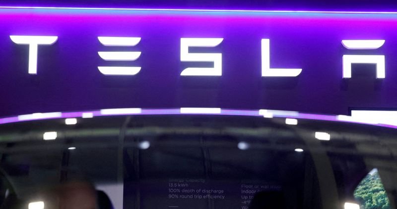 FILE PHOTO: The logo of Tesla on display at the Everything Electric exhibition at the ExCeL London international exhibition and convention centre in London, Britain, March 28, 2024.  REUTERS/Peter Cziborra/File Photo
