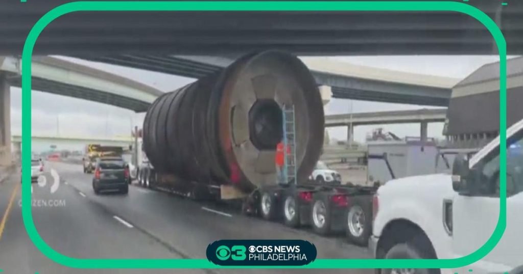Truck hauling large cylinder strikes overhead Conrail bridge causing major traffic delays - CBS News