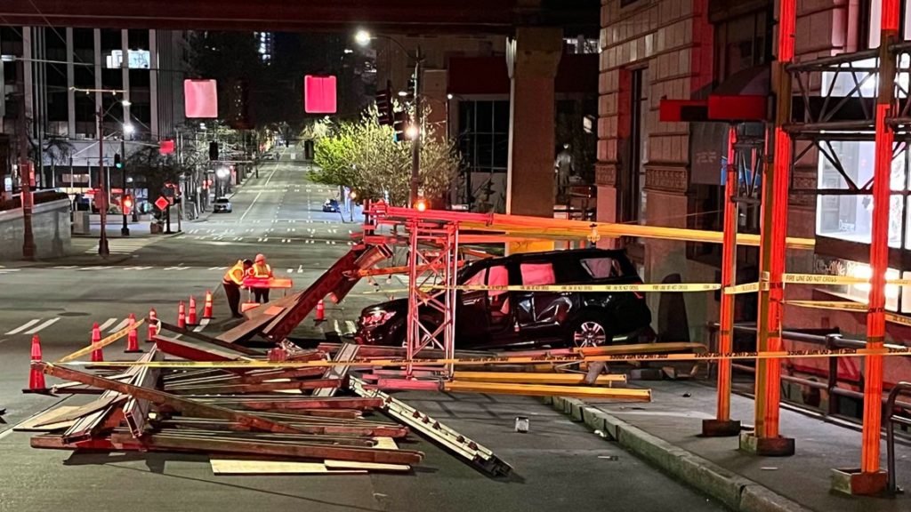 Car crashes into scaffolding surrounding Times Square building in downtown Seattle - KING5.com