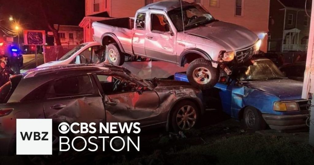 Driver flees crash after pickup truck lands on top of two parked cars in Brockton - CBS News