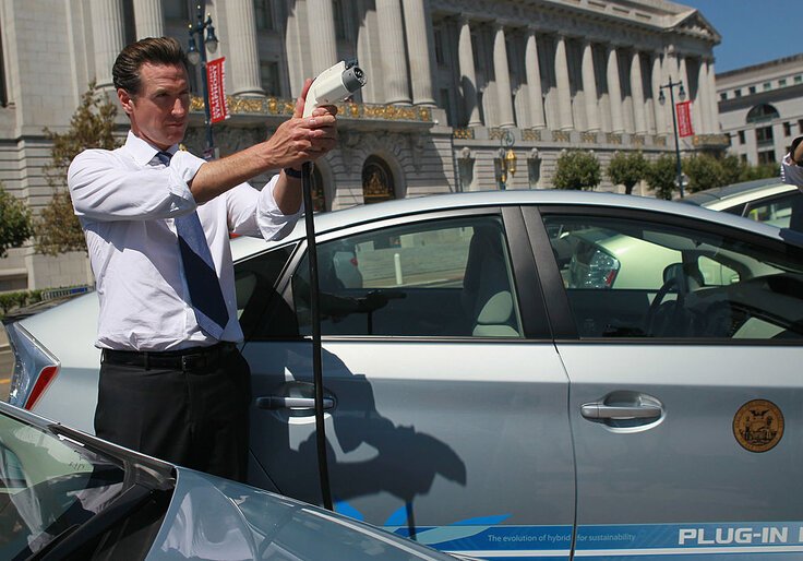 SAN FRANCISCO - AUGUST 25:  San Francisco mayor Gavin Newsom holds a power cable before test driving a plug-in version of the popular Toyota Prius that is one of four on loan to the city for evaluation August 25, 2010 in San Francisco, California. With sales of electric and plug-in hybrid cars expected to increase in the coming years, the Bay Area Air Quality Management District has set aside $5 million to increase the number of electric car charging stations to 5,000 around the Bay Area. There are currently 120 stations in the area.  (Photo by Justin Sullivan/Getty Images)