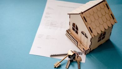 wooden house moder keys and contract on table