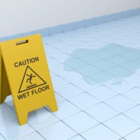wet floor caution sign on tiled floor