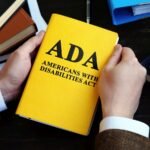 Americans with Disabilities Act ADA law on the wooden surface.